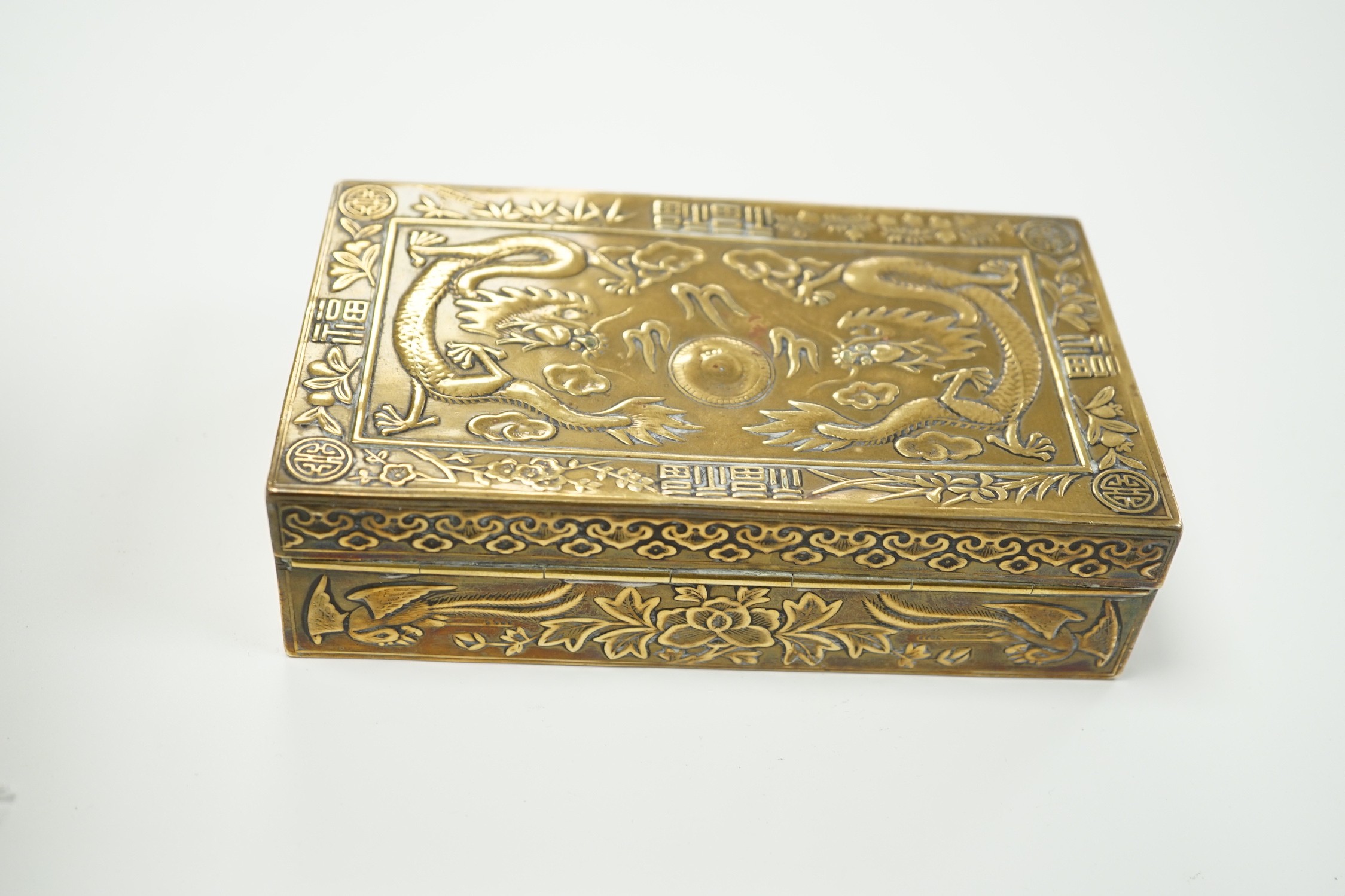 A Chinese brass 'dragon' cigarette box, 15.5cm